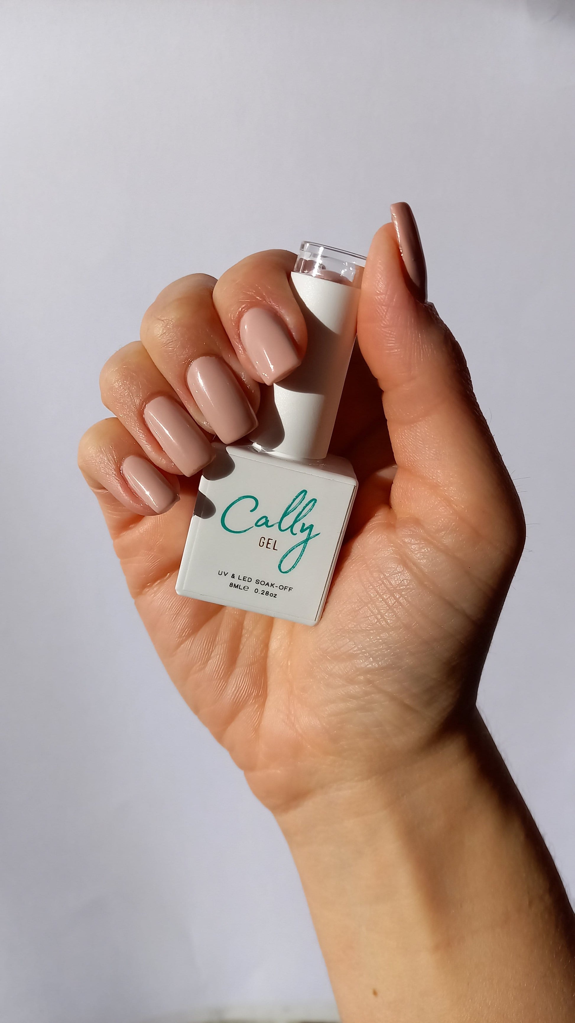 Manicured with Peony Petal Cally Gel Nail Polish and Bottle in Hand